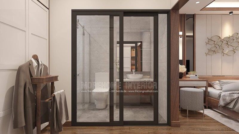Trang trí nội thất phòng ngủ khép kín với xu hướng mở khi sử dụng tấm ốp tường gỗ óc chó như tạo ranh giới phân chia cùng bố trí cửa kính trượt.